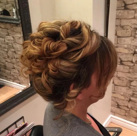 Voluminous Curly Updo with Bangs