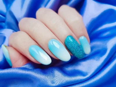 baby blue and glitter nails in a gradient design nails