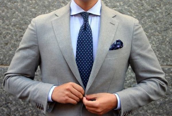 Classic white shirt with a navy blue tie and light grey suit