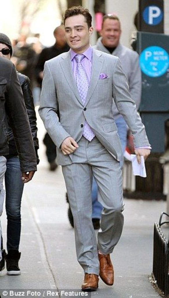 Lavender shirt with a patterned tie and light grey suit