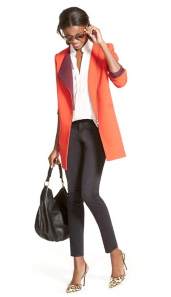Orange blazer paired with tailored black pants and a crisp white blouse