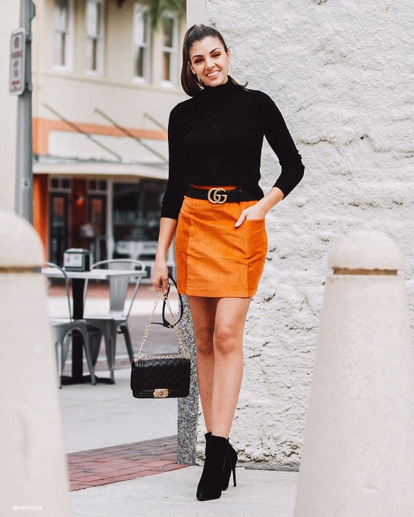 Orange midi skirt paired with a black turtleneck outfit