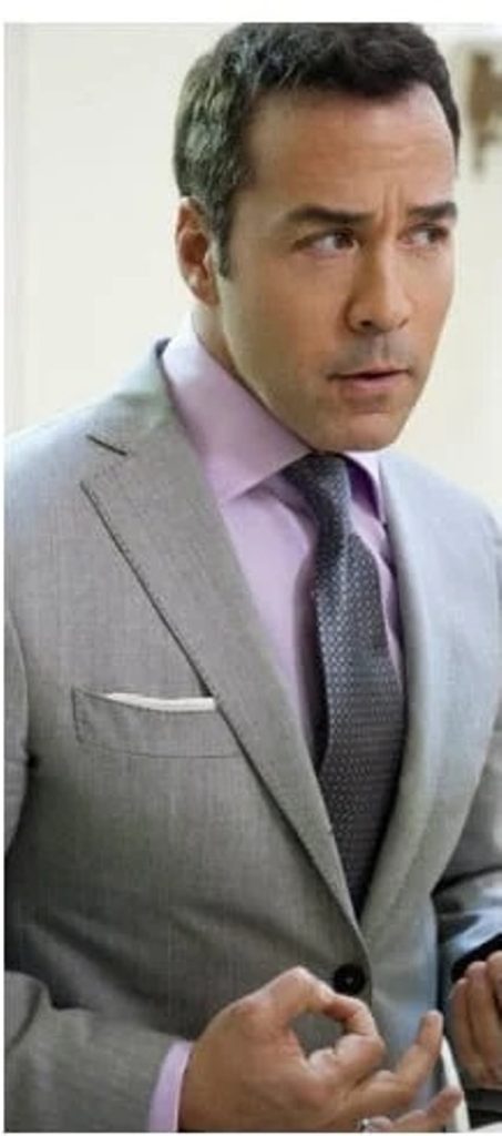 Pink shirt with a navy blue or gray tie and light grey suit