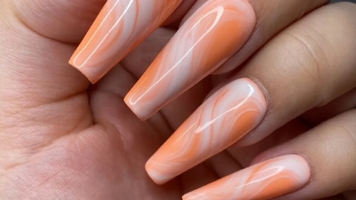 orange and white marbled effect nails